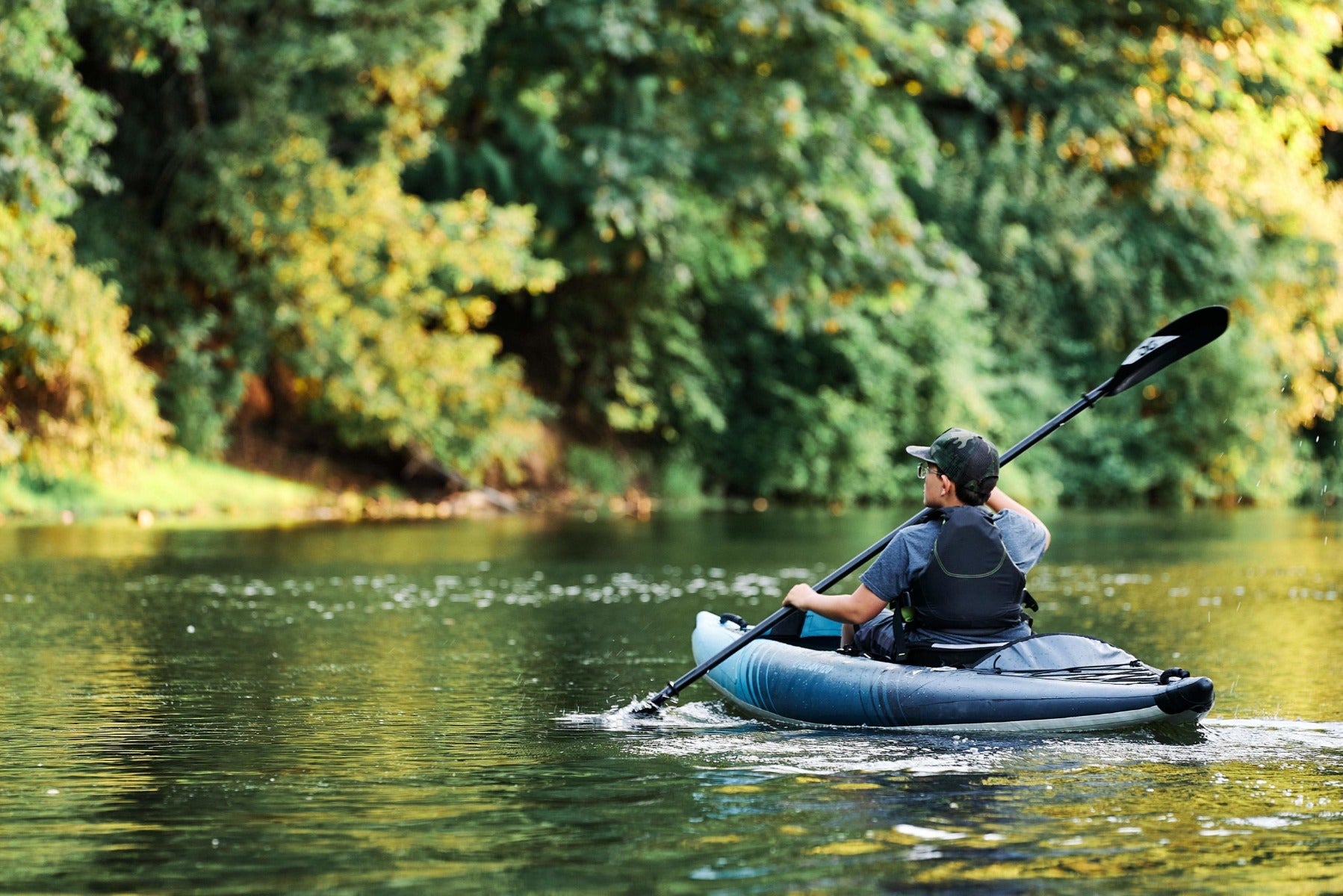Lifestyle image of the Aquaglide Chelan 120 inflatable kayak being used of flat water