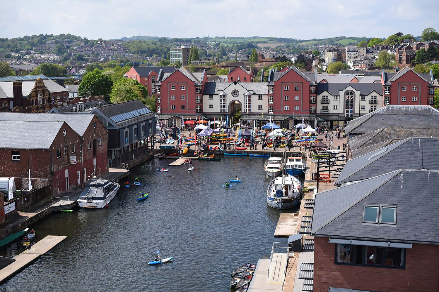 Outside picture of red paddleboards being tried out on the water